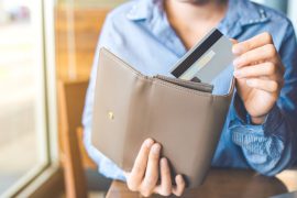 woman pulling credit card out of wallet